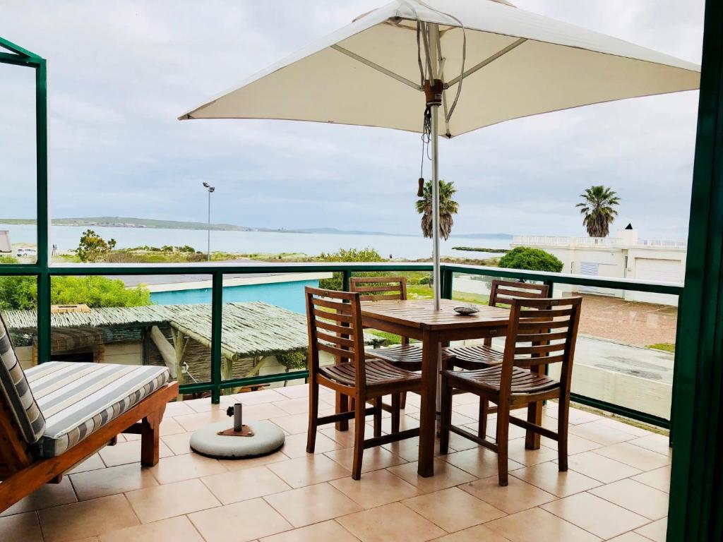 Balcony lounge and dining area overlooking the coast